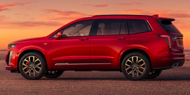 A red Cadillac XT6 parked out in the desert