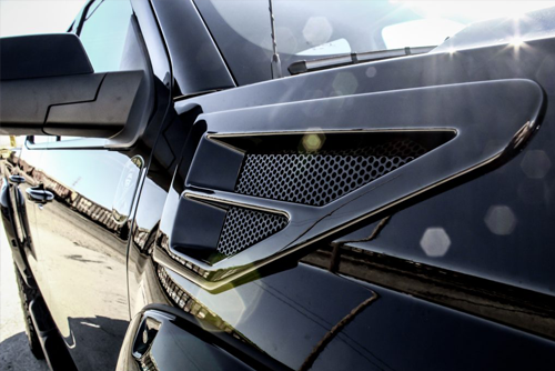 front side angle of red GMC lifted truck