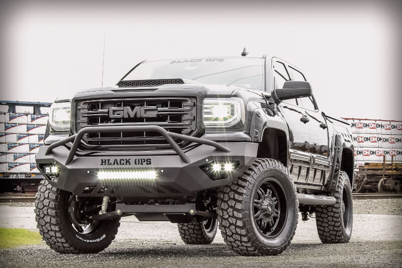 black lifted GMC truck with black ops package