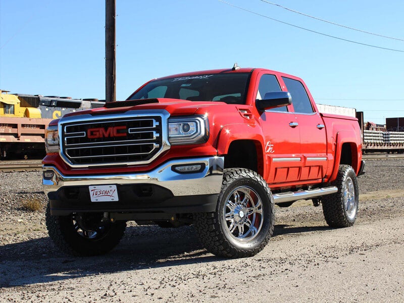 front side angle of red GMC lifted truck
