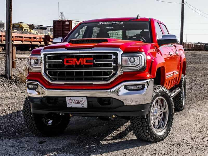 front view of red GMC lifted truck